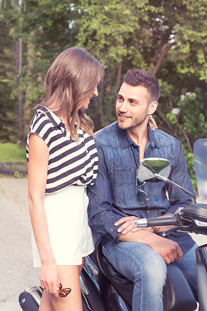 istock Romantic couple talking, man sitting on vespa 476443700