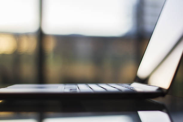 istock glass table with a laptop, shallow depth of field 476444538