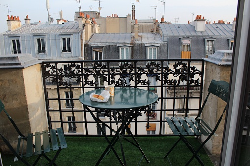Coffee and croissant on the balcony of a French apartment in Montmartre