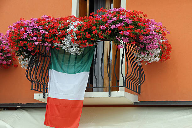 splendid flowering balcony with Geraniums and the Italian flag