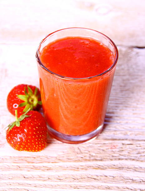 istock Strawberry smoothie in glass with two berries 476450583