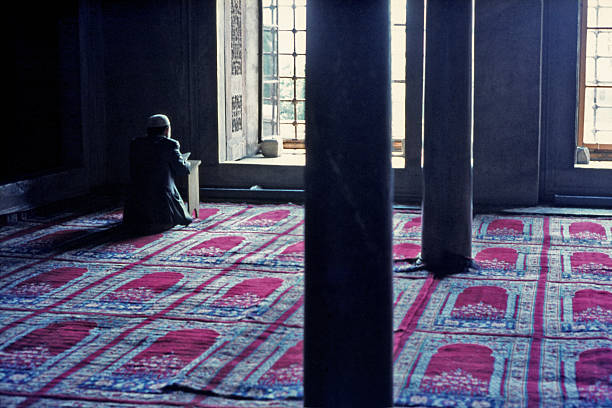 Worship inside the Blue Mosque in Istanbul stock photo