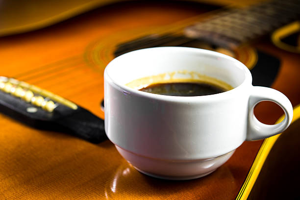 istock Acoustic guitar with a cup of coffee 476451291