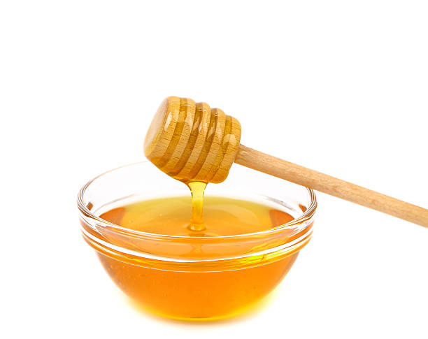 istock Honey dripping from a wooden dipper 476452853