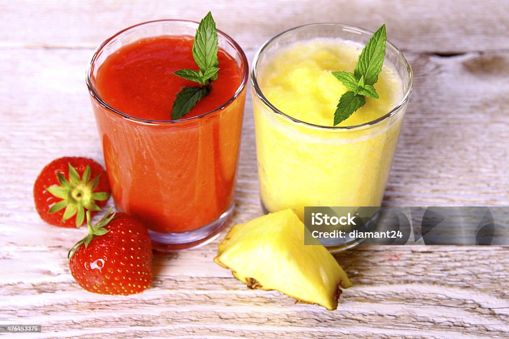 Strawberry, pineapple smoothie in glass with mint, berries Strawberry, pineapple smoothie in glass with mint, berries, soft focus Breakfast Stock Photo