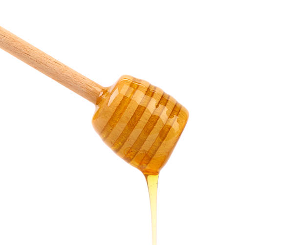 istock Honey dripping from a wooden dipper 476457041
