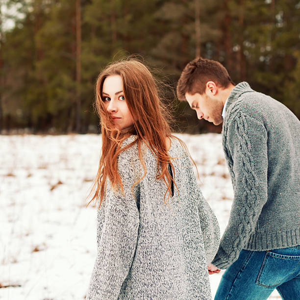 Outdoor attractive couple posing in cold winter weather stock photo