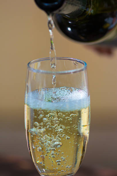 istock Pouring white wine in a glass 476457884