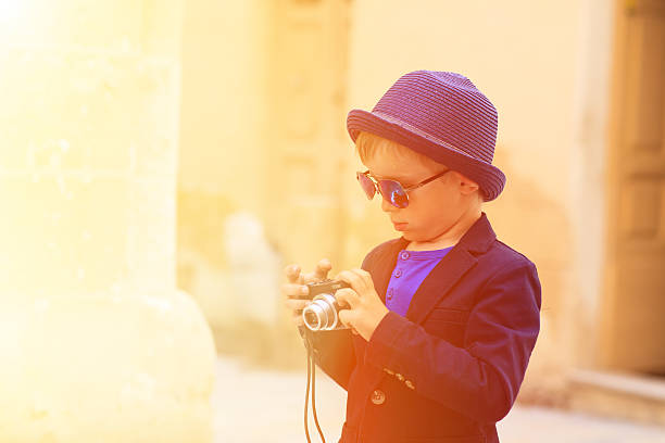 istock little boy taking photos while travel in Europe 476458232