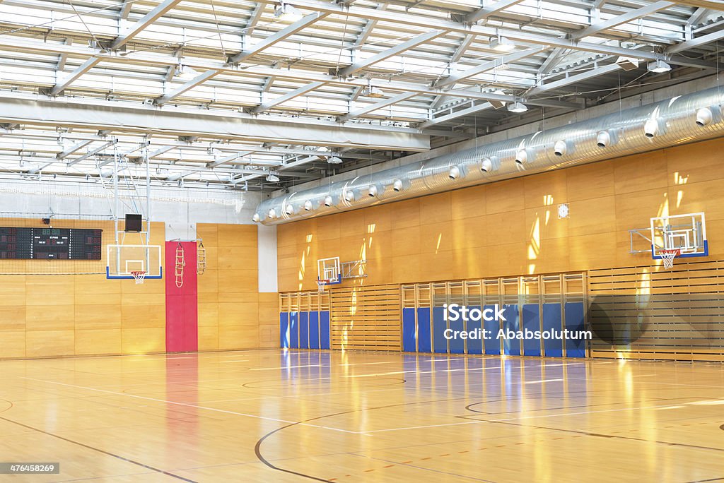 Gymnasium Sport Centre Hall Empty hall used for different sports in the morning sunlight, metal roof with windows, Slovenia. Air Duct Stock Photo