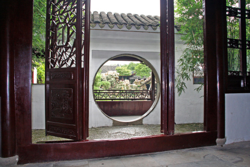 Master of nets garden seen through moon gate.  Master of nets garden is one of the most beautiful gardens in China.