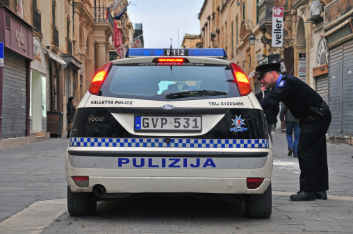 Valletta, Malta - February 28, 2014: Car of Malta police department and constable on the street of Valletta on february 28, 2014. Valletta is a capital and the largest city of Malta.