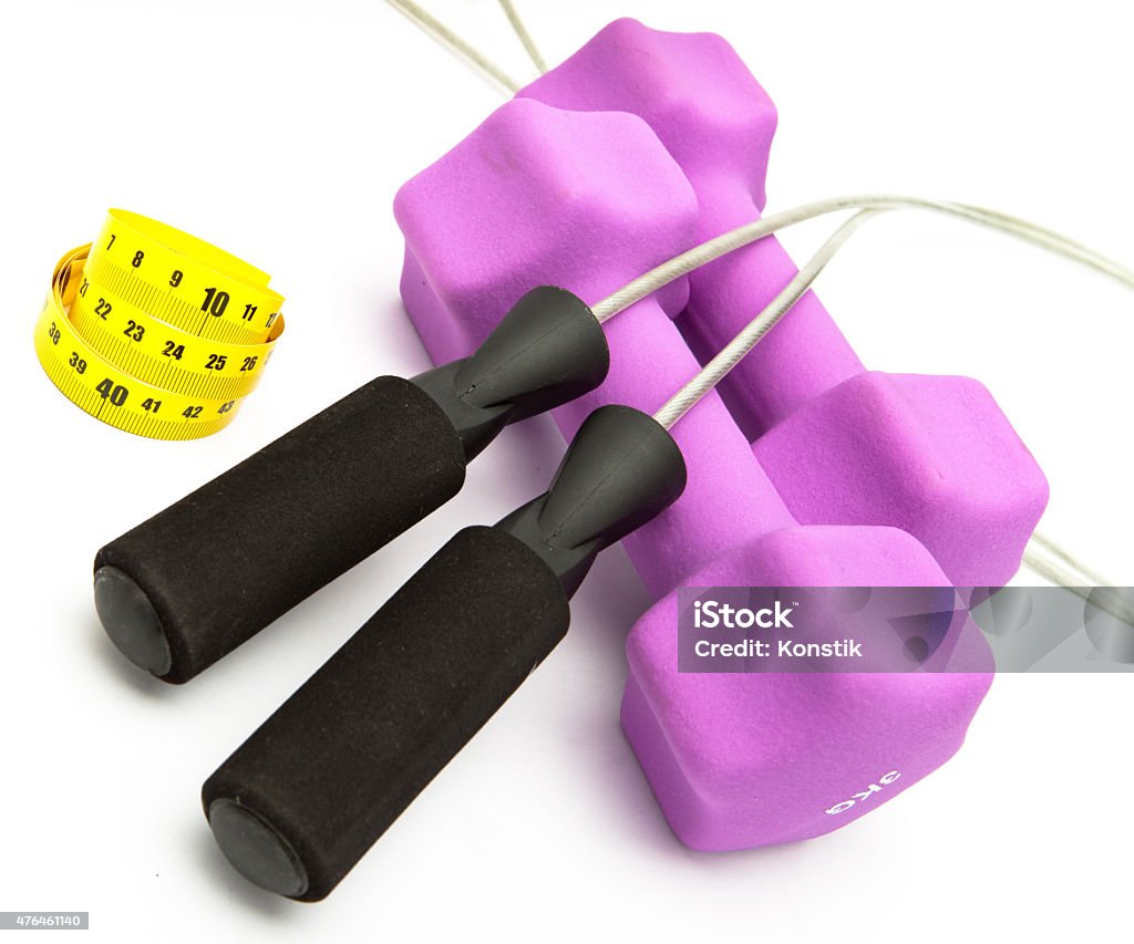 Skipping rope, measuring tape  and Pink dumbbells Skipping rope, measuring tape and and Pink dumbbells 2015 Stock Photo