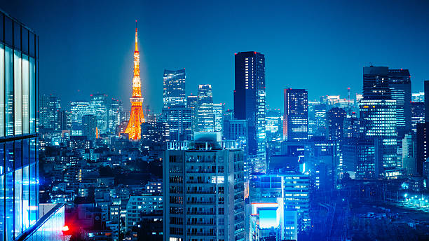Tokyo Skyline at Night Panorama of Tokyo with the Tokyo tower illuminated at night. Japan. tokyo prefecture tokyo tower japan night stock pictures, royalty-free photos & images