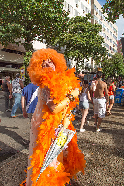 Street Carnival in Rio Rio de Janeiro, Brazil - March 1, 2014: Drag queen photographed few minutes before Ipanema Band 50th Parade. People walking in the background. nudie suit stock pictures, royalty-free photos & images