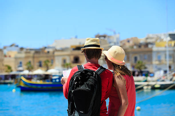 istock tourist couple looking at map while travel in Malta 476461748