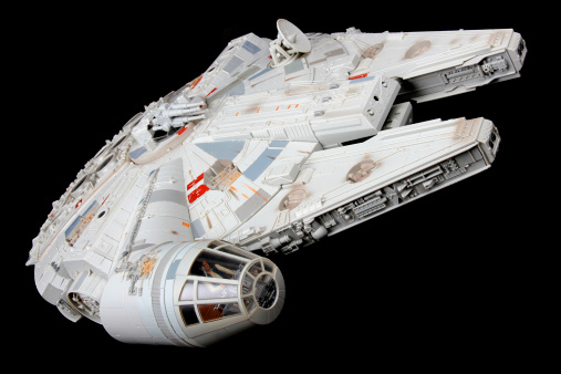 Vancouver, Сanada - February 17, 2014: A toy Millenium Falcon, from the Star Wars movie franchise, on a black background. The toy is made by Hasbro