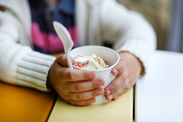 istock Hands of little boy with cup ice cream 476464985