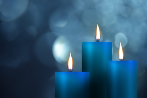Blu candels on blury background.