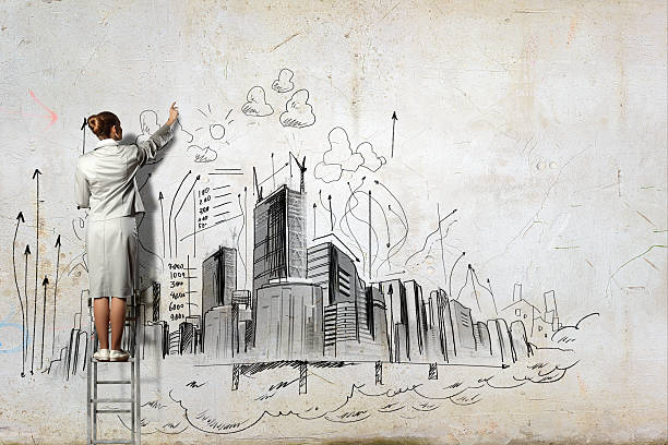 istock Businesswoman drawing on wall 476467469