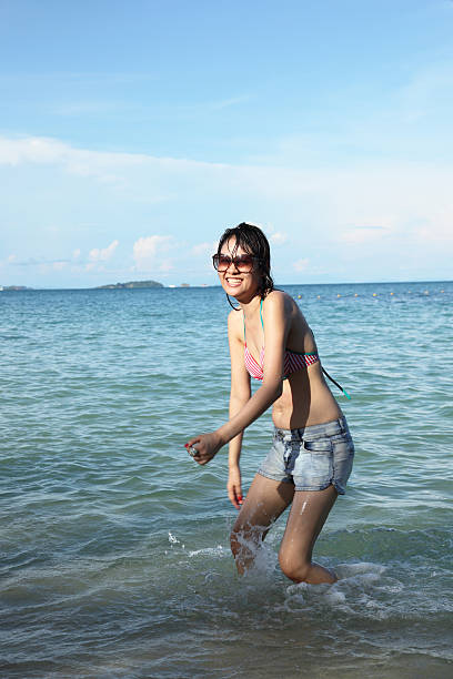 istock Pretty Asian woman posing on the beach 476467503