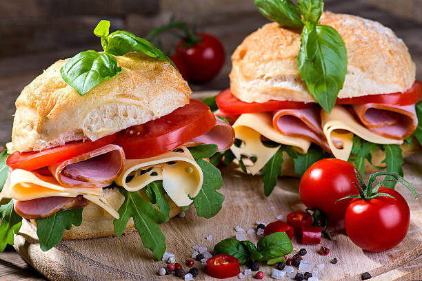 istock Italian ciabatta with ham and raw on the wooden background 476467708
