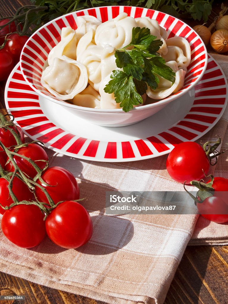chicken drumstick with vegetables dumplings with meat on a wooden table with tomatoes and onionschicken drumstick with vegetables on wooden table 2015 Stock Photo