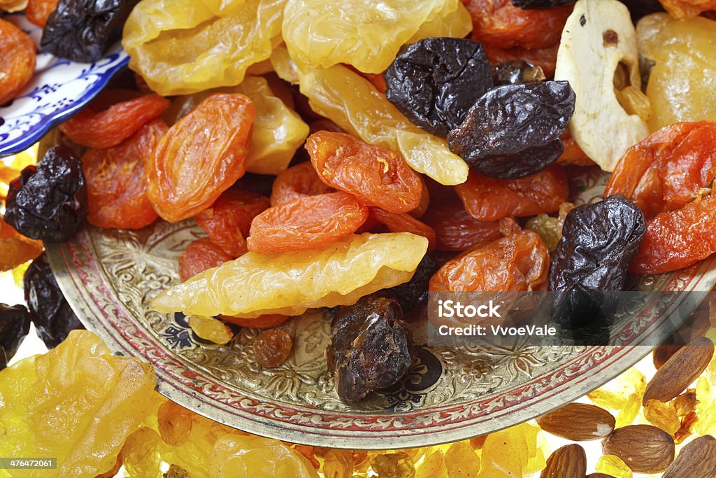 sweet dried fruits oriental dessert - many dried sweet fruits and nuts on plate close up Almond Stock Photo