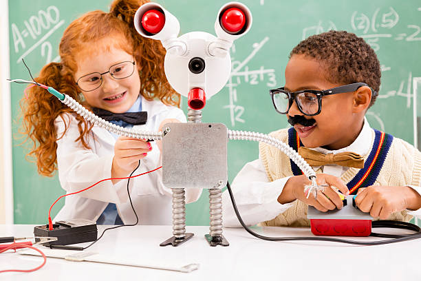 istock Education:  Retro revival children making robot in science lab. 476473527
