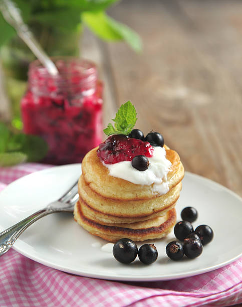 istock Pancake with sour cream and black currant jam 476473959