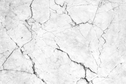 Cracks in the marble pattern tile wall.
