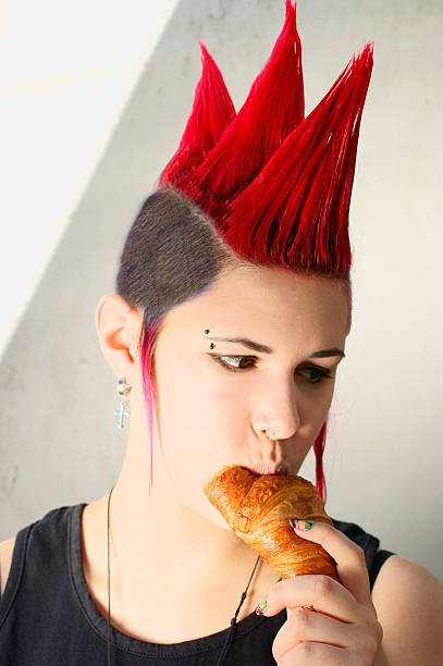 istock Punk girl eating a croissant 476475501