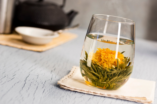 Blooming tea or flower tea is made of tea leaves and flowers, that are tied together and dried into a ball. When the hot water hits the tea ball, it begins to open and 
