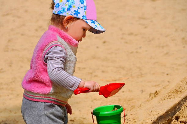 istock The little child playing in the sandbox 476477098