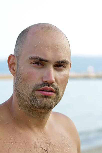 istock Portrait of young man on beach 476479909
