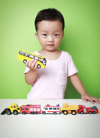 Cute Asian boy and toy car