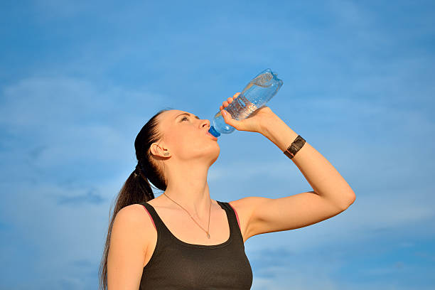 istock Woman drinking water from bottle 476480295
