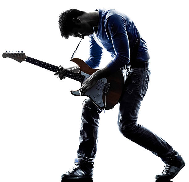 man electric guitarist player playing silhouette one caucasian man electric guitarist player playing in studio silhouette isolated on white background electric guitar photos stock pictures, royalty-free photos & images