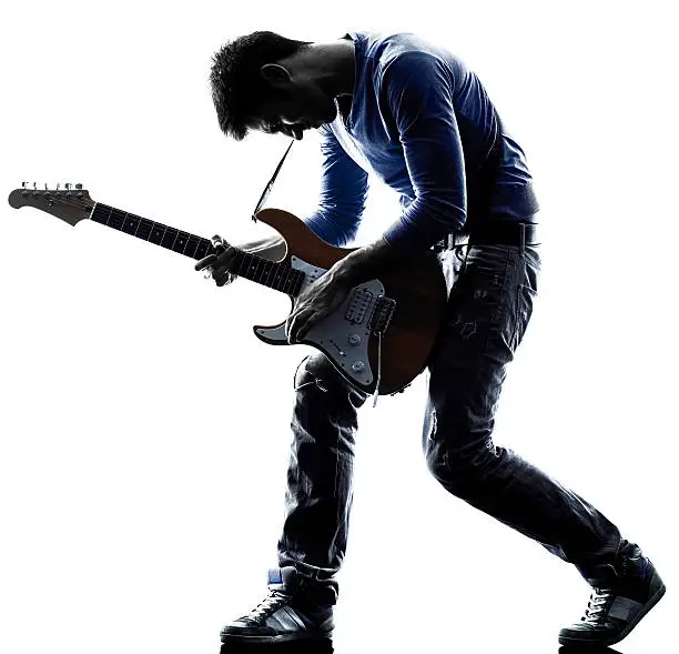 Photo of man electric guitarist player playing silhouette