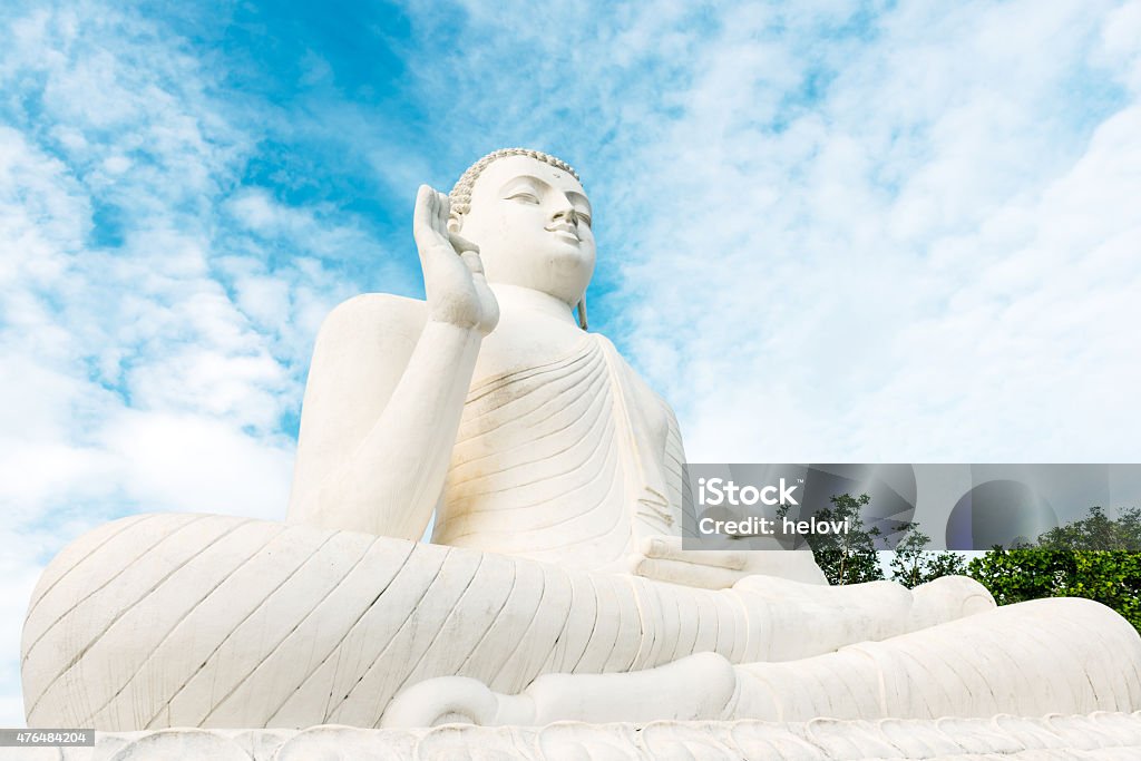 Sitting Buddha at Mihintale Large, white Sitting Buddha at Mihintale against blue sky,  Sri Lanka, Asia. Sri Lanka Stock Photo