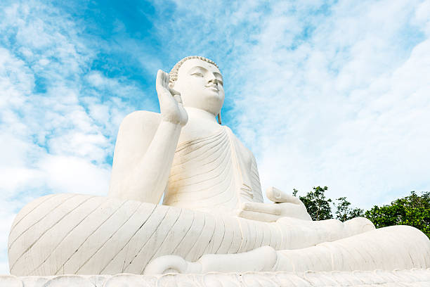 Sitting Buddha at Mihintale Large, white Sitting Buddha at Mihintale against blue sky,  Sri Lanka, Asia. mihintale stock pictures, royalty-free photos & images