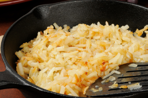 Close up of hash brown potatoes in a cast iron skilled