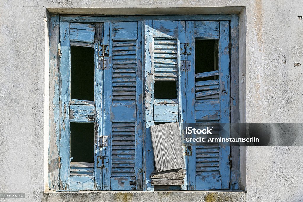 very old and damaged blue shutter very old and damaged blue shutter. Architecture Stock Photo