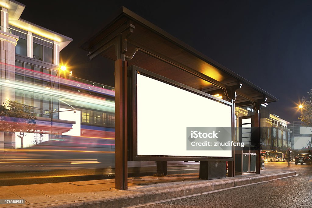 Blank billboard on bus stop at night Billboard Stock Photo