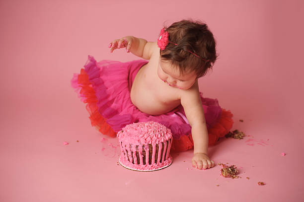 istock Happy Baby Eating her Birthday Cake 476489481