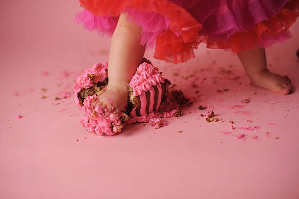 istock Baby Standing in Birthday Cake 476489625