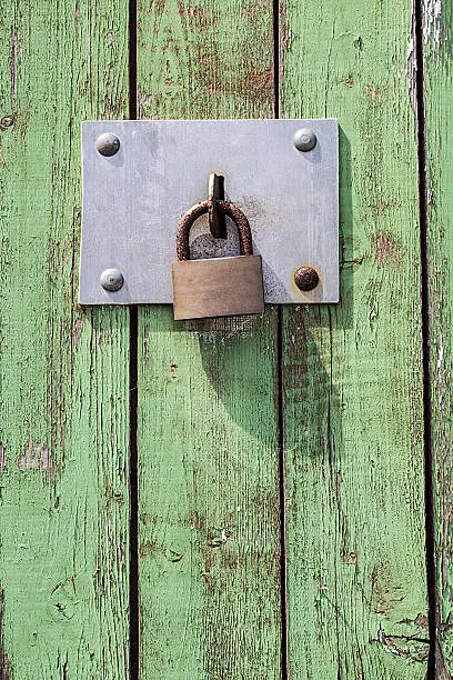 Old key lock on wooden door .