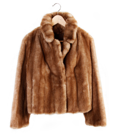 Fur coat on hanger isolated on plain background