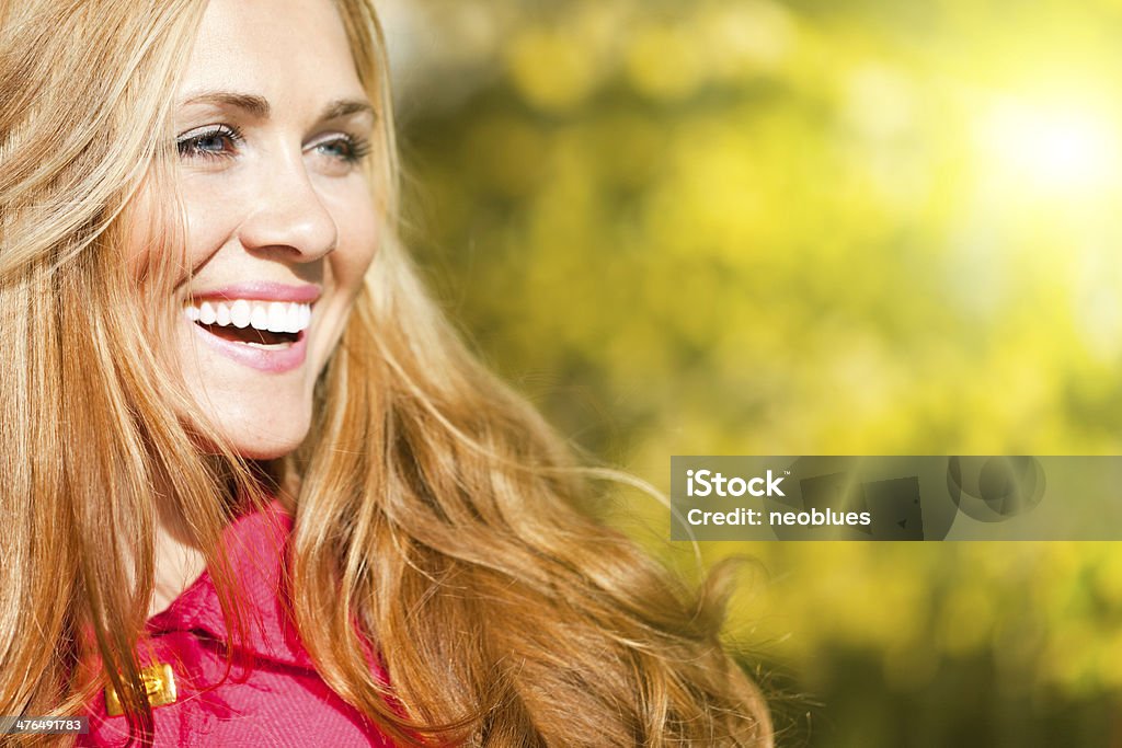 Portrait of a beautiful woman Profile of a beautiful  woman with long hair and pink coat in the  autumn day. Soft Focus Autumn Stock Photo