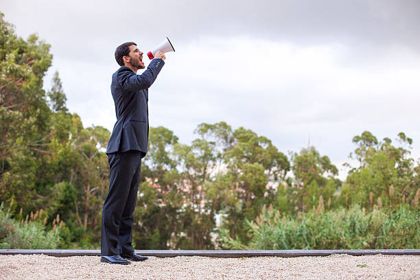 Businessman speeking at his megaphone in outdoor